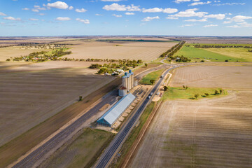 Looking down at the silos and country side in the Mallee on a cloudy day with shadows covering the land. © jodie777