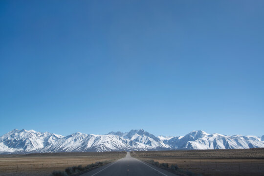 Road running through the Owens Valley with views of the Eastern Sierra