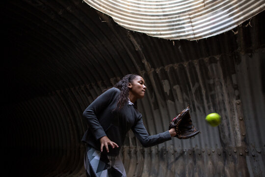 A softball about to go into the glove caught by tween girl
