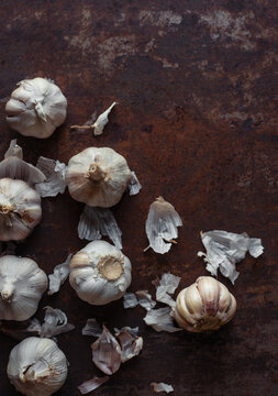 Garlic bulbs on rusty metal floor