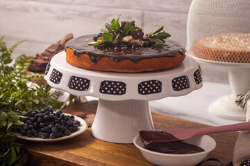 Cake decorated with melted chocolate and blackberries, healthy keto recipe