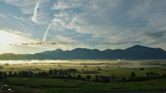 idyllic south bavarian landscape autumn colour alps mountains diffusing fog and horses clouds timelapse