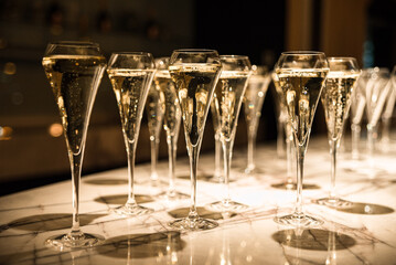 set of champagne glasses on table top (golden light bubbly fine wining in a restaurant)