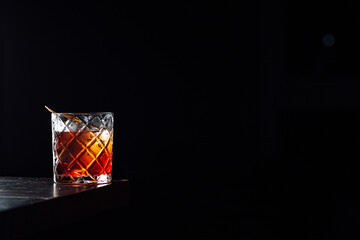 Fototapeta na wymiar Negroni cocktail in a speakeasy bar