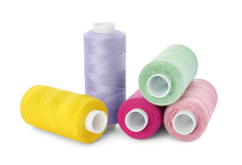 Many different colorful sewing threads on white background