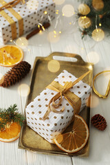 Composition with christmas gift box on white wooden table