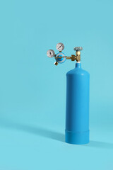 Obraz premium Oxygen tank on light blue background. Medical equipment
