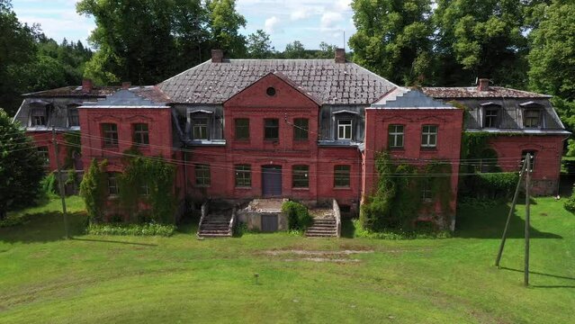 Katvari manor abandoned Latvia red brick mansion building aerial static shot