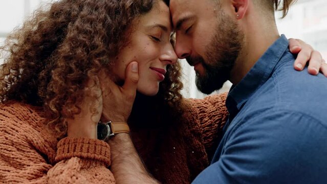 Love, couple and happy man and woman hugging, happiness and sharing intimate moment on sofa at home with care. Romance, relationship and support affection with a young male and female in their house
