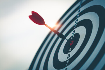 Bullseye has red dart arrow throw hitting the center of a shooting for business. targeting and winning goals business. - 529341399