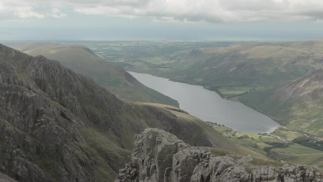 Views of the lake close to Scafell Mountain and the gloomy sky are visible from Scafell Pike Mountain.