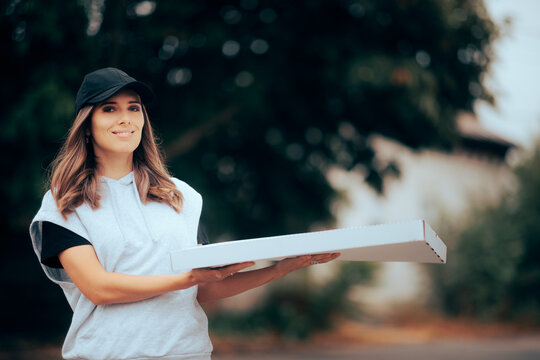 Delivery Girl Holding A Large Box Of Pizza. Fast Food Worker Making A Drop Off On An Online Order
