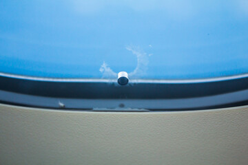 Tiny hole or bleed hole in airplane window compensate for difference between the pressure inside...