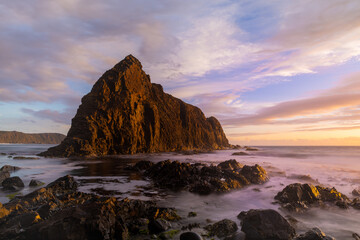 sunset shot of lion rock at south cape bay in the wilderness of south west national park