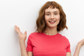 horizontal photo of a joyful, happy, laughing woman spreading her arms to the sides, standing on a white background with an empty space for inserting an advertising layout