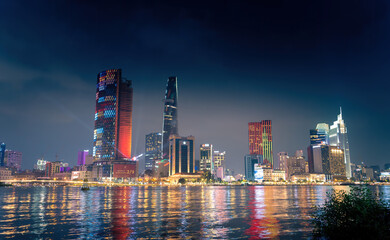 Obraz premium view of Bitexco and IFC One Tower, buildings, roads and Saigon river in Ho Chi Minh city - Laser and lighting show displayed. Travel and landscape concept.