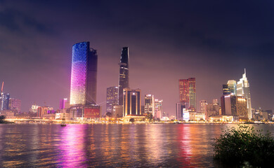 Obraz premium view of Bitexco and IFC One Tower, buildings, roads and Saigon river in Ho Chi Minh city - Laser and lighting show displayed. Travel and landscape concept.