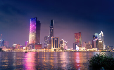 Fototapeta na wymiar view of Bitexco and IFC One Tower, buildings, roads and Saigon river in Ho Chi Minh city - Laser and lighting show displayed. Travel and landscape concept.