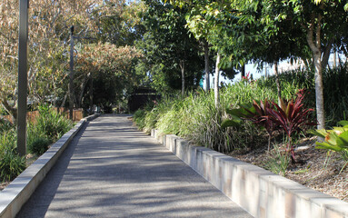 Path through gardens of plants and trees at the Rockhampton waterfront in Queensland, Australia