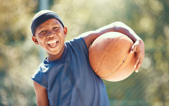 Portrait, basketball and happy black boy ready to train outside for fitness, health and wellness. Sports, childhood and learning with a child playing a sport outdoors for practice, fun or recreation