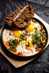Shakshouka - spicy vegetarian breakfast with poached eggs