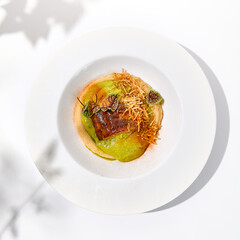 Roasted fish with crispy skin, celery cream and fresh herbs espuma. Fried halibut fillet on mashed celery and crunchy potatoes. Roasted fish fillet in elegant restaurant menu