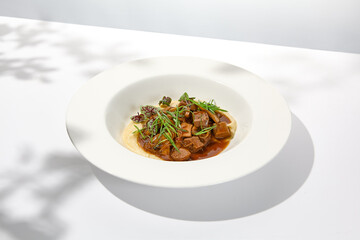 Elegant stew beef with mashed potatoes in  restaurant. Beef bourguignon on light background with...