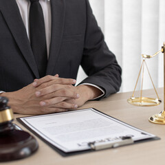 Judge or a lawyer works documents in the courtroom and analyze the various laws for justice and accuracy, Litigation and justice concept.