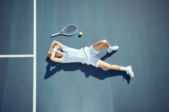 Tired Tennis Sports Loser Man On Floor With Racket, Ball And Court In Summer Sun From Above. Relax And Fitness Player Lying On Ground, Resting Or Taking Break After Match, Game Or Outdoor Practice