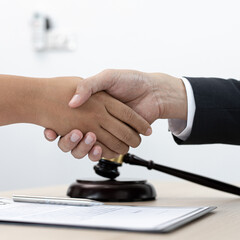 Lawyers or counselors join hands with clients to congratulate the end of the case by the company, Negotiation or settlement of lawsuits concept.