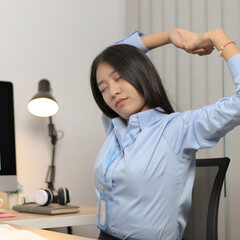 Asian businesswoman is relaxing after overtime working in a office, Happy women resting at work after work is finished.