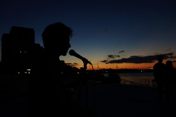 guitarist silhouette at sunset and loving couple
