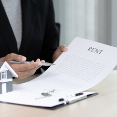 Real estate agent or sales manager has offered home sales and explained the terms of signing the house purchase contract and free home insurance, Finance and after-sales service concept.