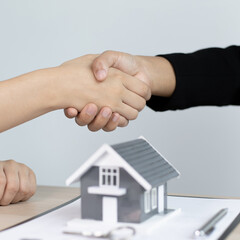 Business success, Real estate agents and customers shake hands to congratulate after signing a contract to buy a house with land and insurance, handshake and Good response concept.