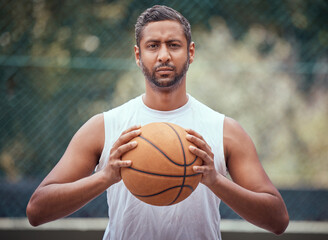 Basketball court, man and serious portrait with ball in outdoor sports venue for practice. Competitive, strong and mature athlete male thinking of a game play strategy for outside match.