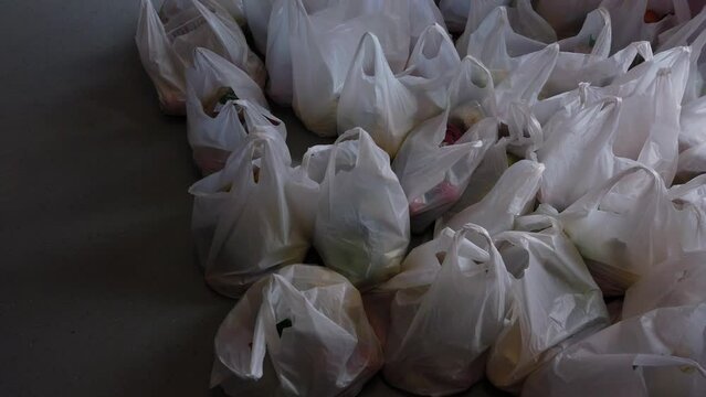 British cost of living crisis food bank bags prepared ready for collection for local struggling poor families tilt up