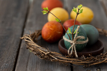 Easter eggs coloured with natural organic colorants: red cabbage, curcuma, onion peel. Handmade home decor, natural elements, eco-friendly, zero waste. Dark wooden background