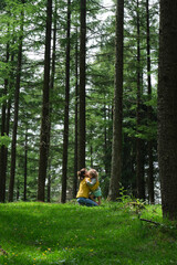 little happy girl hugging her beautiful and mother in the forest. Mother's Love