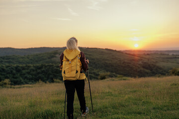 woman gazing at sunrise in mountain
