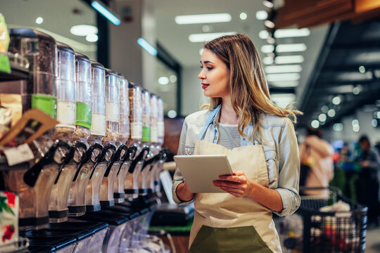 Employee Checking Boxes With Food Product In The Supermarket