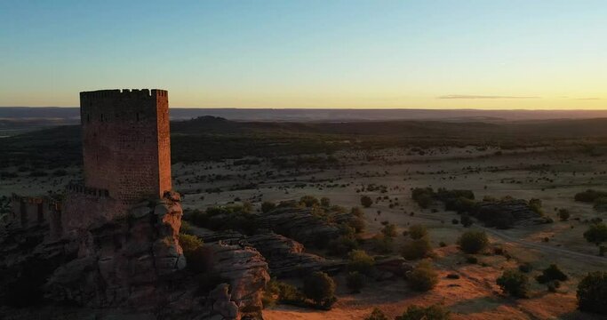 Exterior Of Historic Castillo De Zafra On A Hill Overlooking Rural Landscape In Guadalajara, Spain At Sunset. aerial