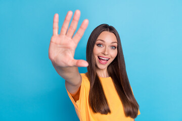 Photo of pretty friendly positive lady demonstrate palm arm give hi greetings symbol empty space...
