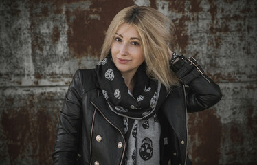 A young woman in leather jacket. Concept of grunge style 90x, mix clothes, outfits for women