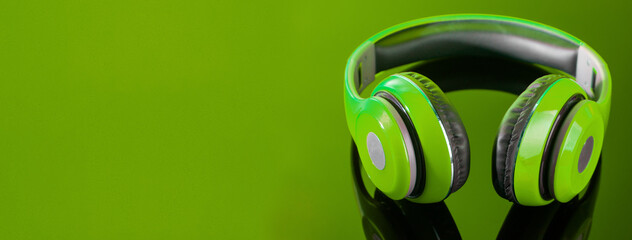 Green headphone isolate on white background.
