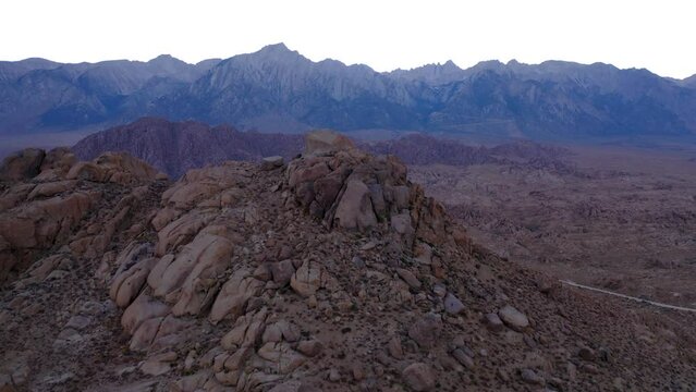 Hills and rock formations of Alabama Hills, view of rugged Mt. Whitney; drone