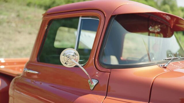 Orange restored retro pickup truck cabin from outside jaw shot 4K
