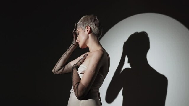 Stunning beauty model posing at studio in light flashes. Professional fashion model. Celebrity 4k