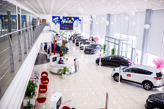 Auto showroom. Toyota brand cars are in a row, polished beautiful modern cars with a shiny surface reflecting beautiful light illumination in the hall. Copy space. Shymkent Kazakhstan April 15, 2022