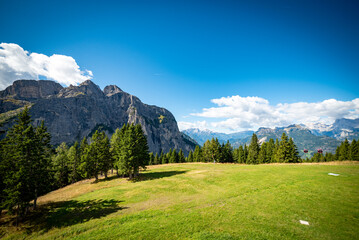 Obraz premium landscape with clouds over the mountains dolomiti monte Pelmo, with blue sky and green trees in Italy