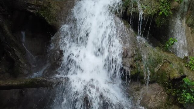 waterfall falling down in the middle of the forest